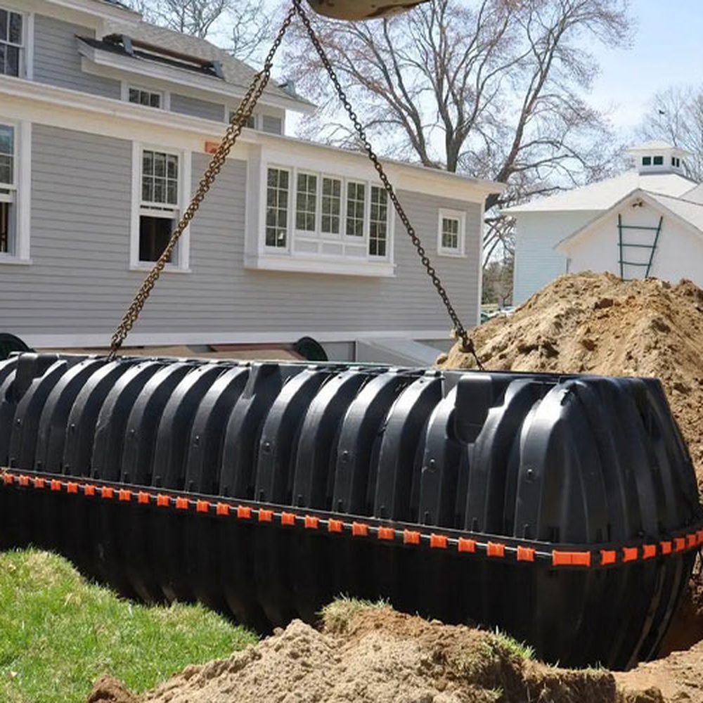 Poly septic tank being installed beside a home