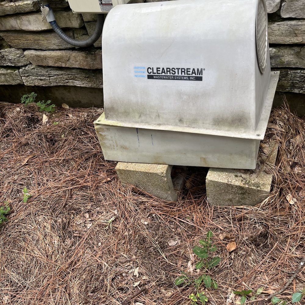 Aerobic septic unit installed beside a home
