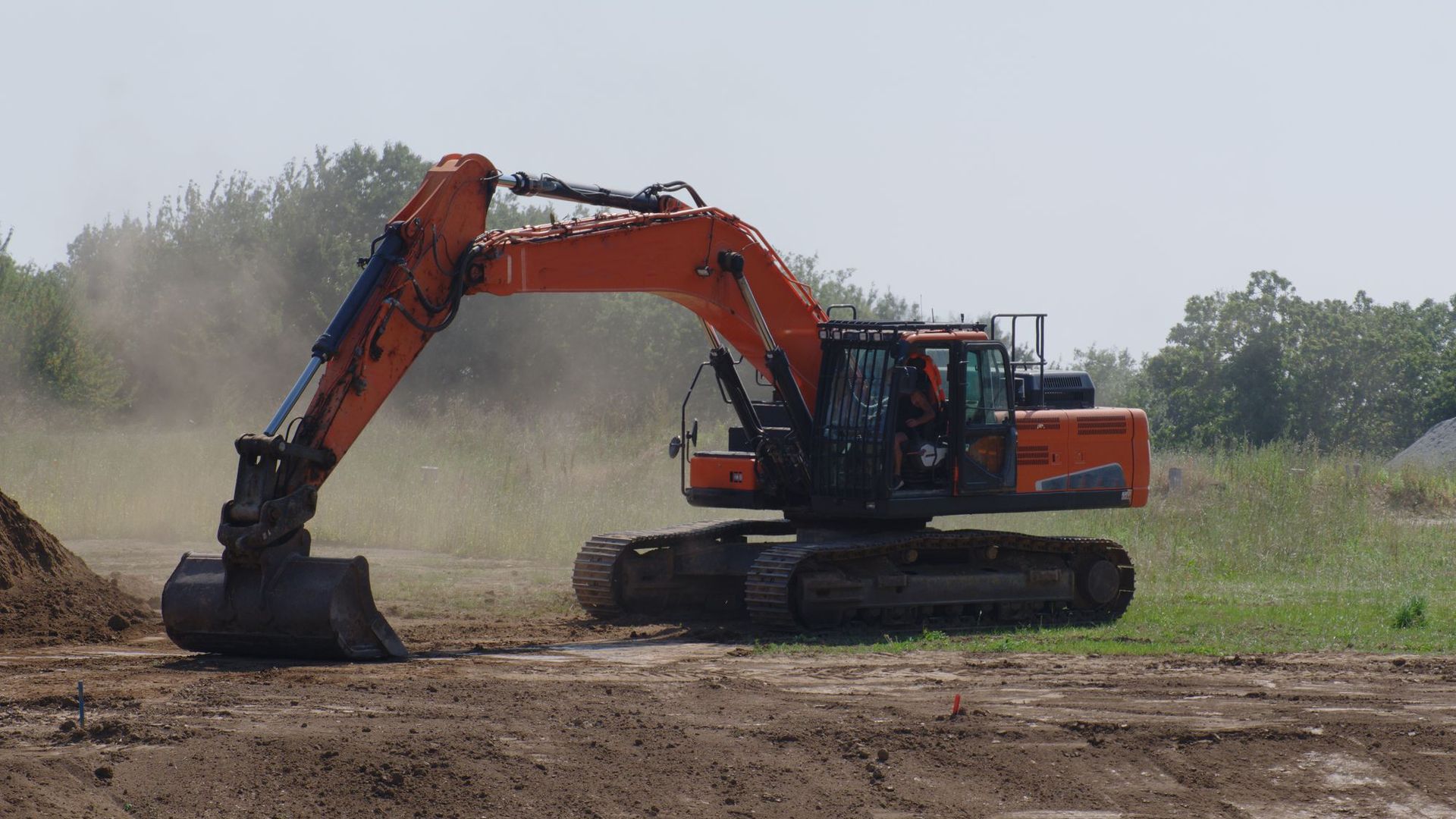 Excavator leveling ground for a septic system near Hockley, TX