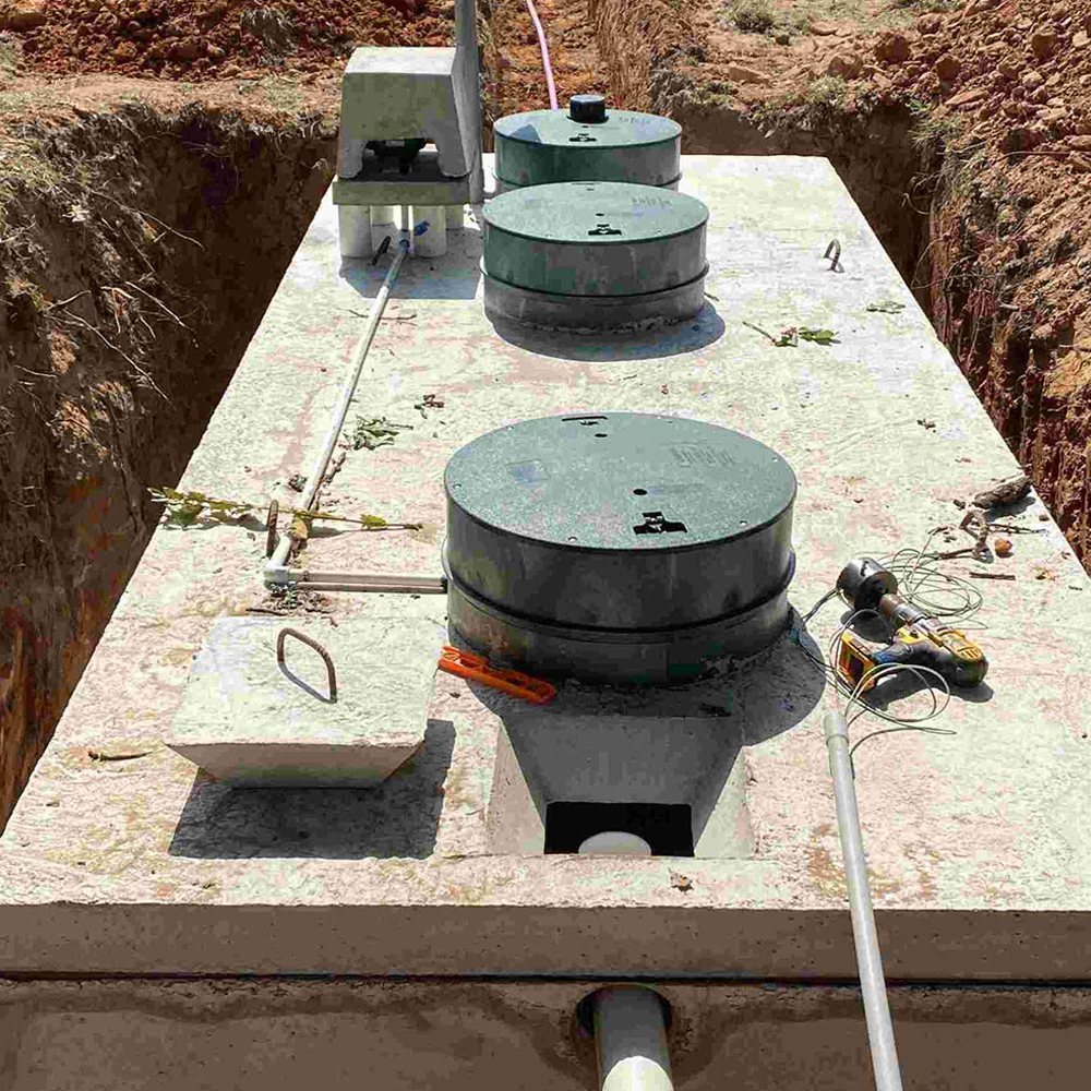 Concrete septic tank set in a trench