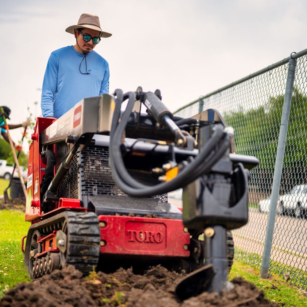 Operator running a compact trencher